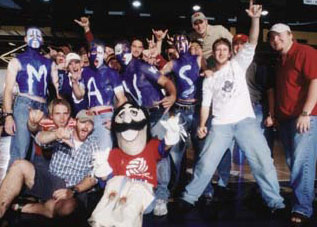 The KA Krazies surround mascot Sam Maverick after a home volleyball match.