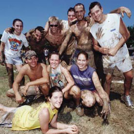A muddy team huddle at the 13th annual oozeball tournament.