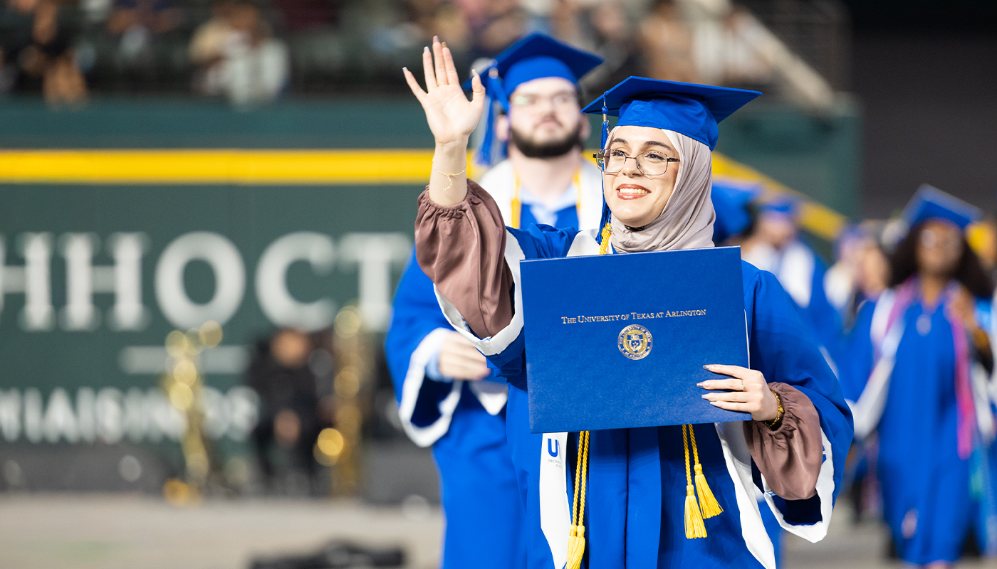 woman graduating holding diploma