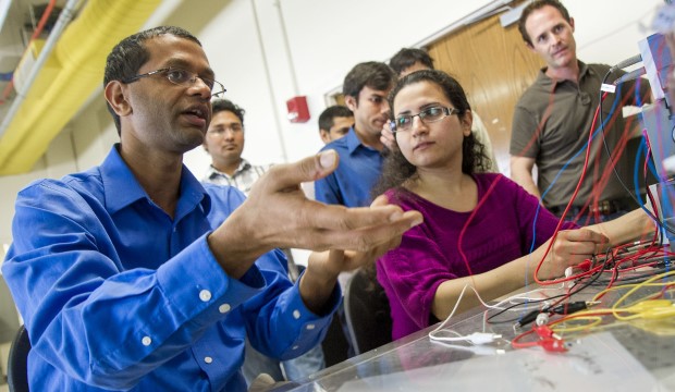 Mechanical and aeronautics engineering Professor Ankur Jain with students looking at a computer screen.