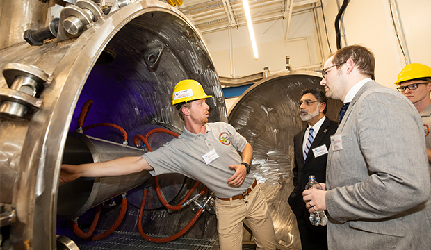 An engineer shows off the new arc-heated, hypersonic wind tunnel at UTA.
