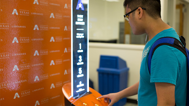 Student using the literature dispenser