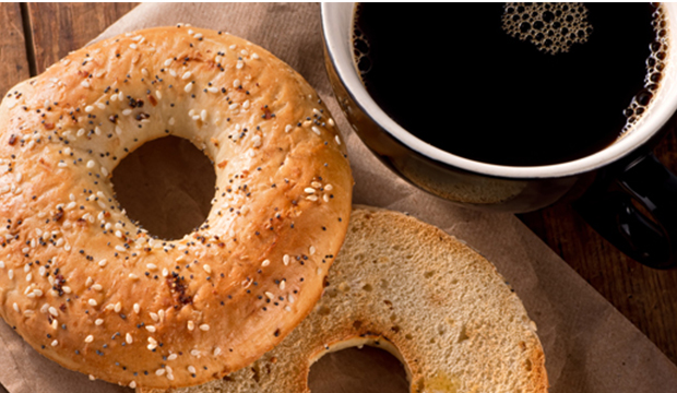 Bagels and coffee on a table.