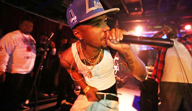 Young black male singer with microphone.