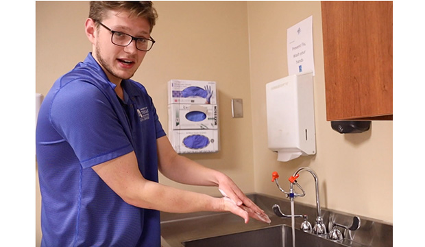 Man showing property handwashing techniques.