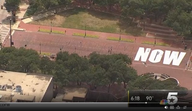 "End Racism Now" painted on a brick street in downtown Fort Worth.