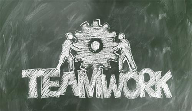 Teamwork graphic showing a two workers with wrenches and one big cog.