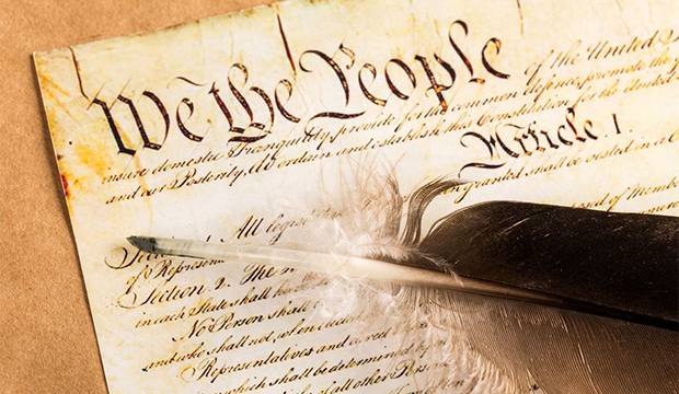 U.S. Constitution with quill pen