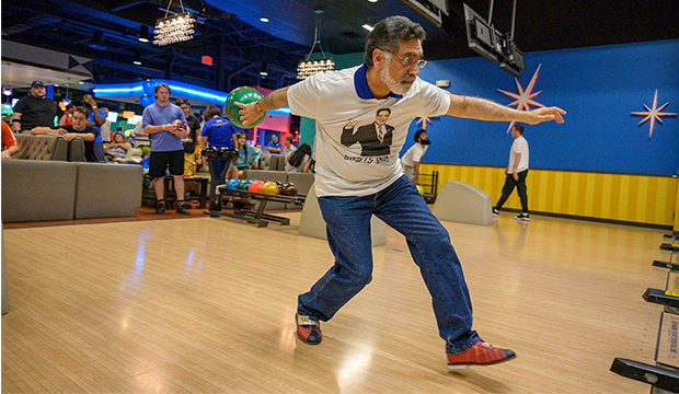 UTA President Vistasp Karbhari throwing a bowling ball at Bowling with the President