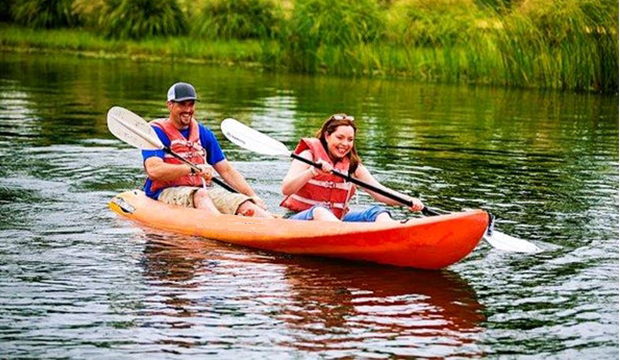 two people in a kayak on a lake.