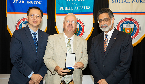 President Vistasp Karbhari, Provost Teik Lim present endowed professors and chairs with framed certificates.
