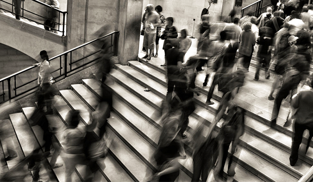 An crowd in an urban environment, moving about their business.