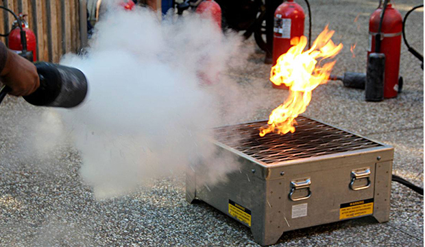 First extinguisher being used on a small fire.