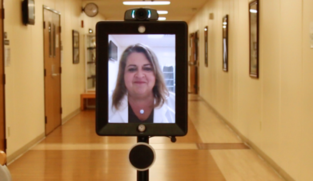 Digital screen on pole showing a nursing instructor.