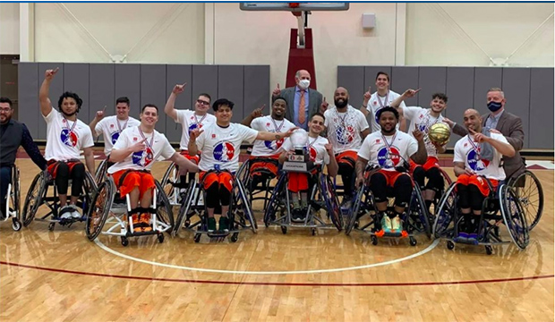 Movin' Mavs wheelchair basketball team with 2021 NWBA collegiate championship trophy.