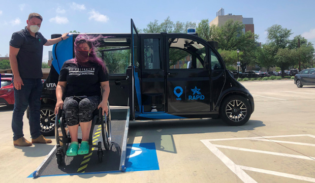 Young woman in wheelchair exiting the RAPID automous vehicle.