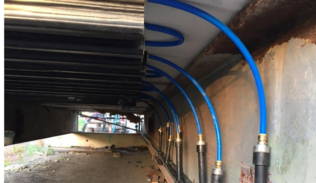 Pipes under a bridge to use hydrothermal method to de-ice bridges in winter.