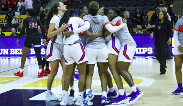 Lady Mavs basketball team hugs after winning the semi-final game of the Sun Belt Conference championship.