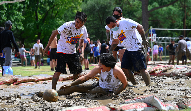 Oozeball participants falling in the mud.