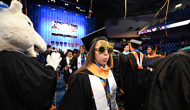 Graduate wearing gold sparkley sunglasses with "2022" on top.