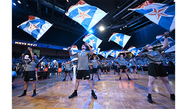 Flag corps members wave UTA's "A" logo flags at College Park Center during the fall 2022 MavsMeet Convocation.