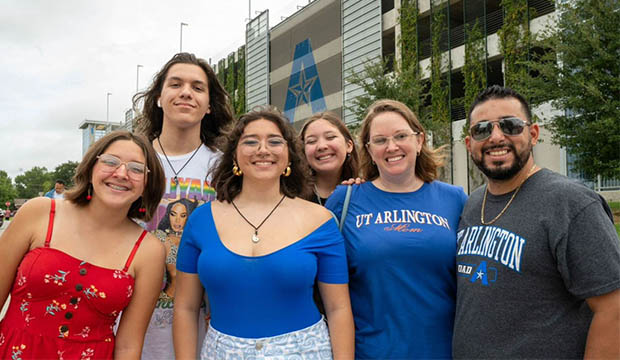 Family standing outside the West Garage on Move-In Day.