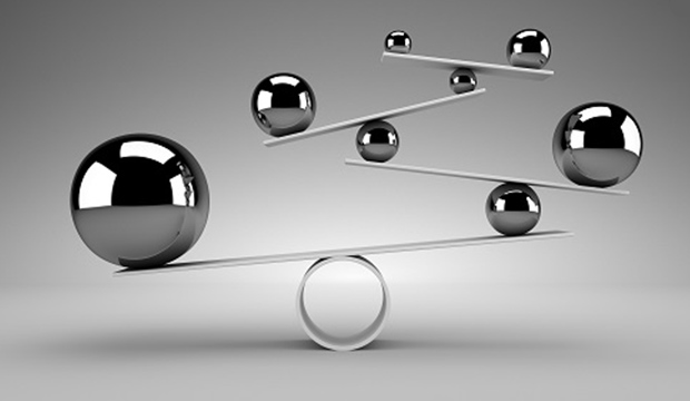 Ball bearings balanced on a metal ledge