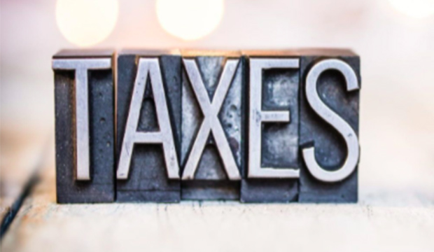 Lead printers letters spelling TAXES.