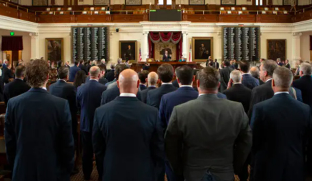 Texas House members stand at end of session.