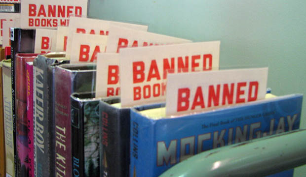 Row of books with each having a book marker that says "Banned Book"