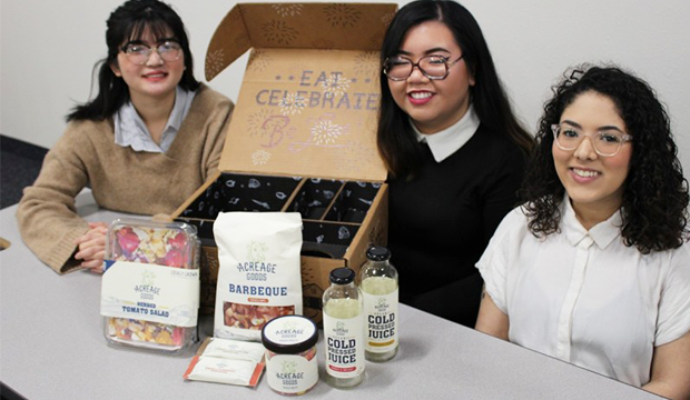 Student with projects from art packaging class.