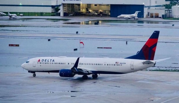Airplane with flooding on runway.
