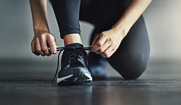 Hands tying laces on a shoe