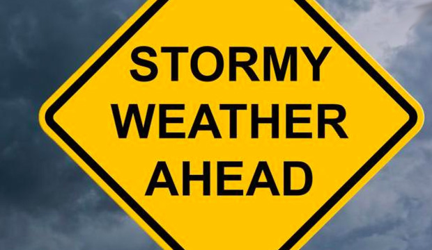 Yellow caution sign with words "Stormy Weather Ahead"