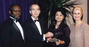 Alumni Association President Michael Burton, UTA President Robert E. Witt, School of Nursing honoree Remy Cabatu Tolentino and Nursing Dean Liz Poster.
