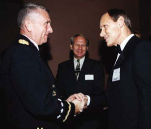 Gen. Tommy Franks introduces himself to fellow Distinguished Alumni Gala honoree Robert G. Davis.