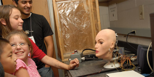children amused by artificial face
