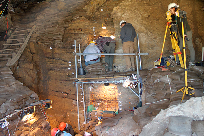 Researchers working in a cave