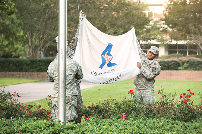 ROTC student raising flag