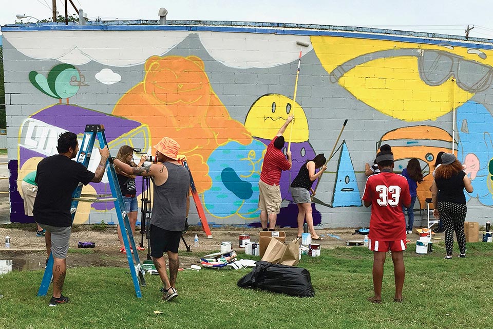 High school students creating a mural