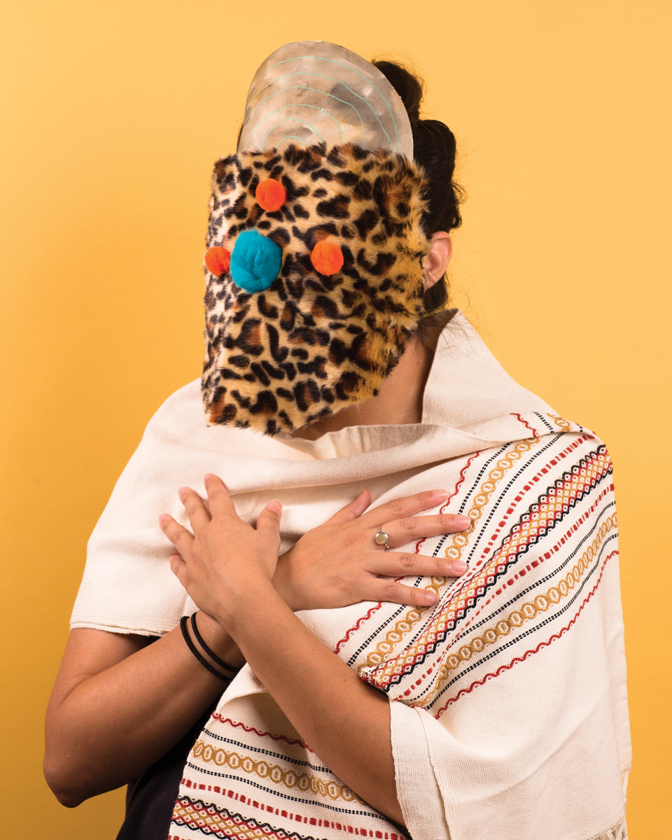 Person wearing one of a leopard pattern mask and cloth shaw