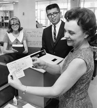 Norweita Graham displays a computer punch card