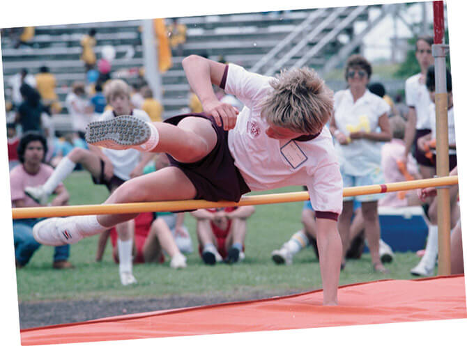 A Special Olympian flies over the high jump bar during the 1986 regional Special Olympics in Haltom City.