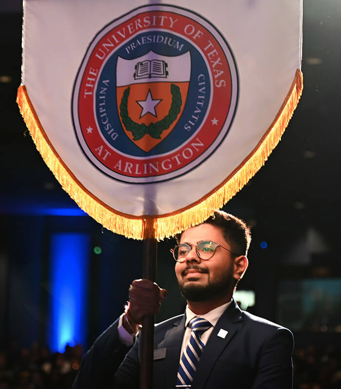 Man holding Phi Kappa Phi flag