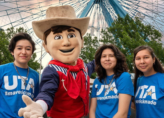 From left: Scholarship winners Ruth Briones, Llasmin Arce, and Ugenia Silva with Little Big Tex.